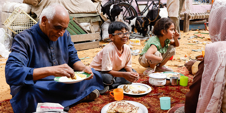 Family of four enjoy a meal together.